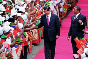Chinese President Xi Jinping (L) shakes hands to members of a welcoming committee eyed by Tanzanian President Jakaya Kikwete upon his arrival at Julius Nyerere International airport in Dar Es Salaam on March 24, 2013.  Xi Jinping and Peng Liyuan are on a two day visit to Tanzania, their first stop in Africa as part of an international trip. AFP PHOTO/JOHN LUKUWI        (Photo credit should read JOHN LUKUWI/AFP/Getty Images)